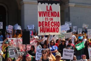 Crowd protesting for housing as a human right in 2023.